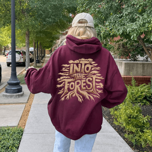 Featuring the phrase "Into the Forest" uniquely crafted in tree branch lettering, this design brings the beauty and mystery of the woods to life.