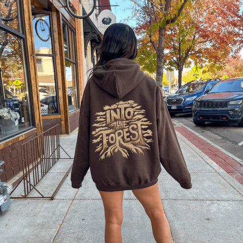 Featuring the phrase "Into the Forest" uniquely crafted in tree branch lettering, this design brings the beauty and mystery of the woods to life.