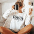 Small Town Hockey Mom sweatshirt with black typography design on a cozy white crewneck, perfect for rink moms and hockey season apparel
