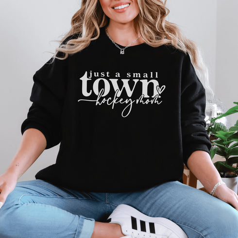 Small Town Hockey Mom sweatshirt with white typography design on a cozy white crewneck, perfect for rink moms and hockey season apparel