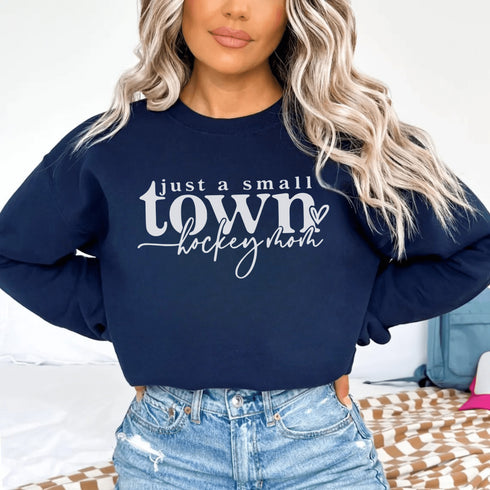 Small Town Hockey Mom sweatshirt with white typography design on a cozy white crewneck, perfect for rink moms and hockey season apparel