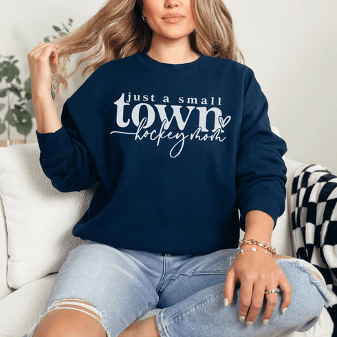 Small Town Hockey Mom sweatshirt with white typography design on a cozy white crewneck, perfect for rink moms and hockey season apparel