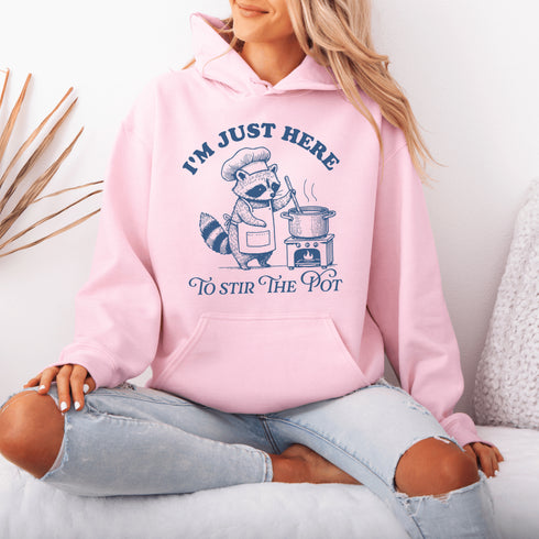 Meet your new favorite hoodie—starring a sarcastic raccoon who’s as skilled at cooking up drama as stirring actual soup.