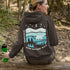 This hoodie features a silhouetted polar bear wandering across layered frozen prairie hills, this design captures the quiet majesty of nature.