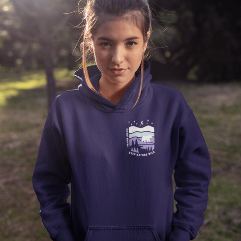 Featuring a sleek polar bear silhouette wandering through layered frozen prairie hills, this hoodie design evokes the serenity of untouched nature.