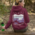 Featuring a sleek polar bear silhouette wandering through layered frozen prairie hills, this hoodie design evokes the serenity of untouched nature.