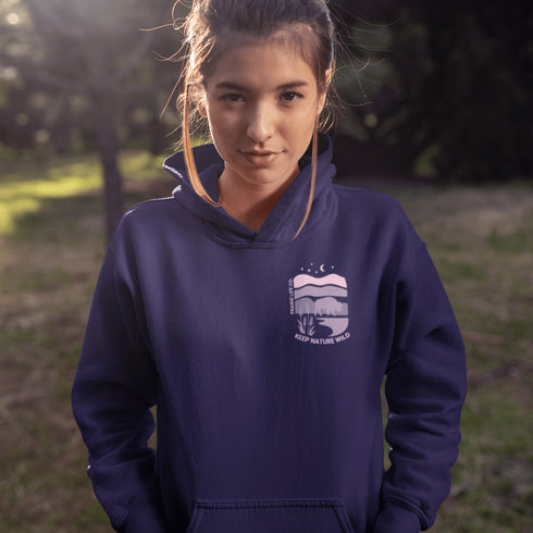 The hoodie showcases a bison standing above wheat with an open prairie sky, blending modern style with the wild spirit of the Canadian countryside.
