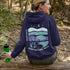 This hoodie features a color-blocked design in pastel blue and purple hues. The graphic showcases a powerful bison standing above wheat with an open prairie sky
