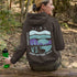 This hoodie features a color-blocked design in pastel blue and purple hues. The graphic showcases a powerful bison standing above wheat with an open prairie sky