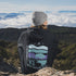This hoodie features a color-blocked design in pastel blue and purple hues. The graphic showcases a powerful bison standing above wheat with an open prairie sky