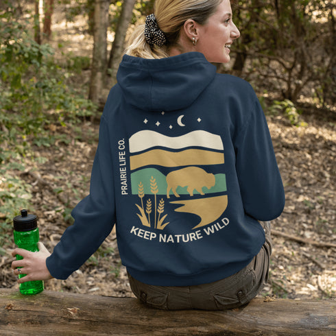 Celebrate the beauty of the prairies with this bold color-blocked hoodie featuring a striking bison silhouette, golden wheat fields, and an open prairie sky.