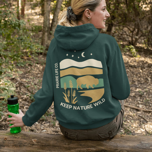 Celebrate the beauty of the prairies with this bold color-blocked hoodie featuring a striking bison silhouette, golden wheat fields, and an open prairie sky.