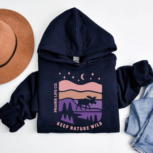 The Keep Nature Wild Hoodie features our signature moose and wilderness design, inspired by the landscapes that make the prairies and beyond so unforgettable.