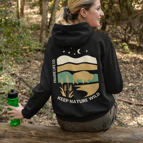 Celebrate the beauty of the prairies with this bold color-blocked hoodie featuring a striking bison silhouette, golden wheat fields, and an open prairie sky.