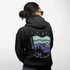 This hoodie features a retro-style landscape graphic with prairie hills, pine trees, a campfire, a tent, and a night sky filled with stars and a crescent moon.