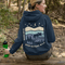 This hoodie features a moose silhouette roaming across prairie hills, pine trees with stars scattered above and a crescent moon glowing softly.