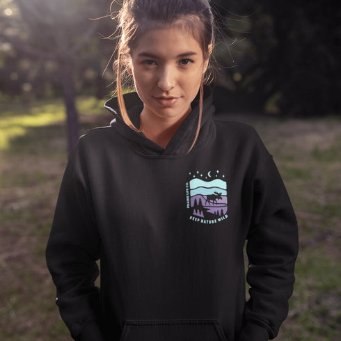 Featuring a bold moose silhouette set against a serene forest landscape, this design celebrates adventure, conservation, and life beyond the pavement.