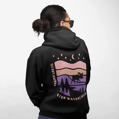 Inspired by Canada’s rugged landscapes and iconic wildlife, this design features a striking moose silhouette set beneath a starry sky and rolling wilderness.