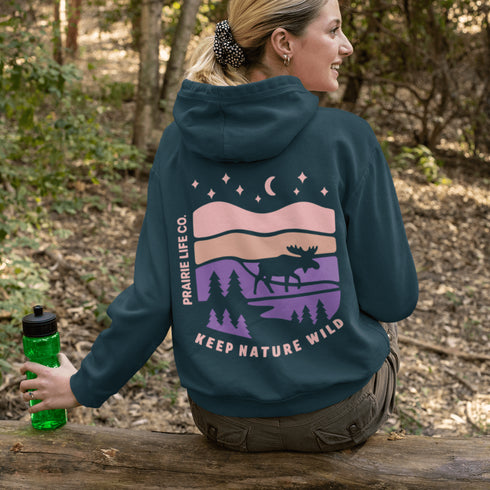 Inspired by Canada’s rugged landscapes and iconic wildlife, this design features a striking moose silhouette set beneath a starry sky and rolling wilderness.