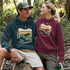 Featuring a bold moose silhouette layered over rolling hills, pine trees, and a starry night sky, this hoodie is a tribute to Canada’s wild landscapes.