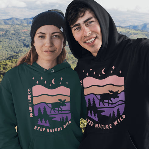 The Keep Nature Wild Hoodie features our signature moose and wilderness design, inspired by the landscapes that make the prairies and beyond so unforgettable.