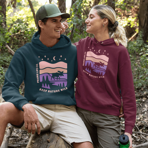 The Keep Nature Wild Hoodie features our signature moose and wilderness design, inspired by the landscapes that make the prairies and beyond so unforgettable.