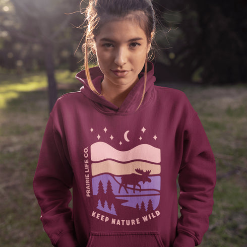 The Keep Nature Wild Hoodie features our signature moose and wilderness design, inspired by the landscapes that make the prairies and beyond so unforgettable.