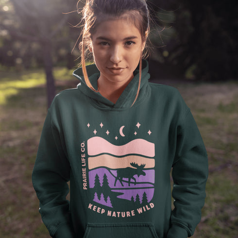 The Keep Nature Wild Hoodie features our signature moose and wilderness design, inspired by the landscapes that make the prairies and beyond so unforgettable.