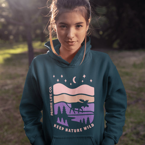 The Keep Nature Wild Hoodie features our signature moose and wilderness design, inspired by the landscapes that make the prairies and beyond so unforgettable.