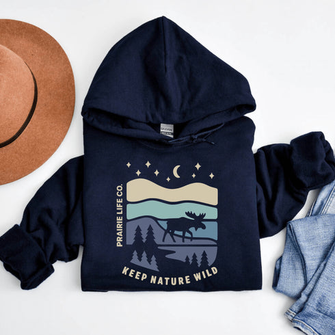 Featuring a moose design paired with a nature-inspired landscape, this hoodie reflects the beauty of Canada’s wild spaces and the importance of protecting them.