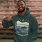 Featuring a moose design paired with a nature-inspired landscape, this hoodie reflects the beauty of Canada’s wild spaces and the importance of protecting them.