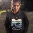 Featuring a moose design paired with a nature-inspired landscape, this hoodie reflects the beauty of Canada’s wild spaces and the importance of protecting them.