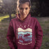 Featuring a moose design paired with a nature-inspired landscape, this hoodie reflects the beauty of Canada’s wild spaces and the importance of protecting them.