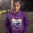 Featuring a moose design paired with a nature-inspired landscape, this hoodie reflects the beauty of Canada’s wild spaces and the importance of protecting them.