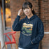 Featuring a bold moose silhouette layered over rolling hills, pine trees, and a starry night sky, this hoodie is a tribute to Canada’s wild landscapes.