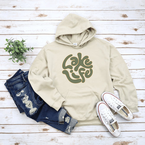 Embrace the serene vibe of lakeside living with our "Lake Life" Hoodie, a perfect blend of comfort and nostalgia. Crafted with a nod to the laid-back, timeless appeal of lake life, this hoodie features the phrase "Lake Life" prominently displayed in a charming retro font that evokes memories of sunny days spent by the water, laughter-filled evenings around campfires, and the soothing tranquility of nature.