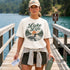 Woman wearing a 'Lake Life' t-shirt on a dock by a lake