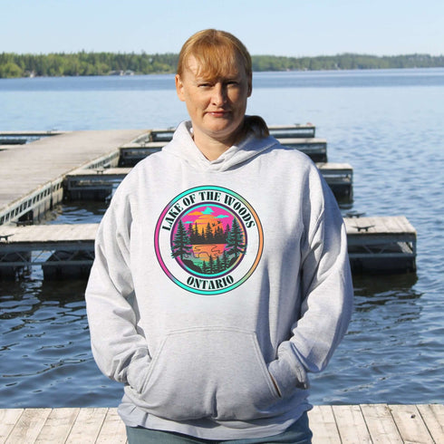 Featuring a stunning lake scene with a vibrant sunset, this hoodie captures the beauty of Lake of the Woods in Ontario, where tranquil waters meet the warm glow of a setting sun.