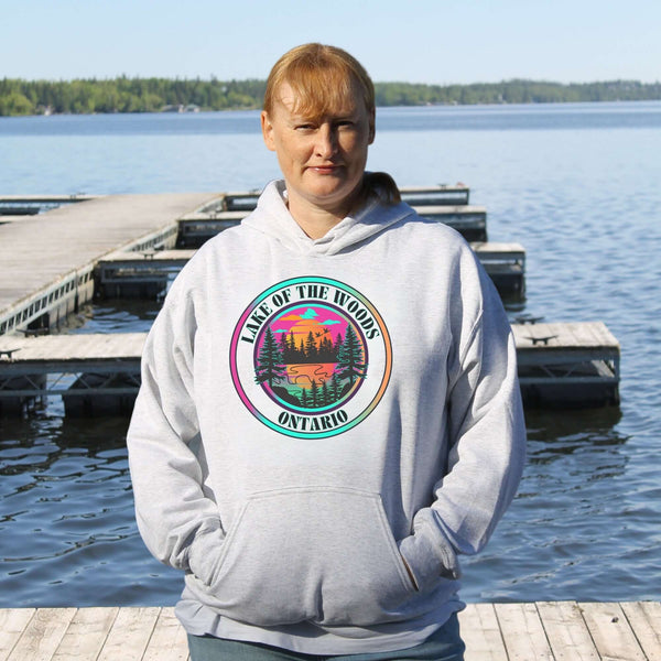 Featuring a stunning lake scene with a vibrant sunset, this hoodie captures the beauty of Lake of the Woods in Ontario, where tranquil waters meet the warm glow of a setting sun.