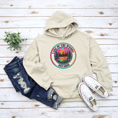 Featuring a stunning lake scene with a vibrant sunset, this hoodie captures the beauty of Lake of the Woods in Ontario, where tranquil waters meet the warm glow of a setting sun.