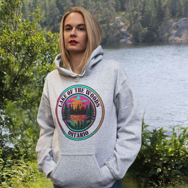 Featuring a stunning lake scene with a vibrant sunset, this hoodie captures the beauty of Lake of the Woods in Ontario, where tranquil waters meet the warm glow of a setting sun.