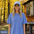 Comfort Colors 1717 unisex t-shirt featuring a coordinating left chest pocket design and large outdoor-inspired back graphic, shown in a lifestyle setting and available in multiple garment-dyed colours.
