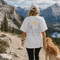 Comfort Colors 1717 unisex t-shirt featuring a coordinating left chest pocket design and large outdoor-inspired back graphic, shown in a lifestyle setting and available in multiple garment-dyed colours.