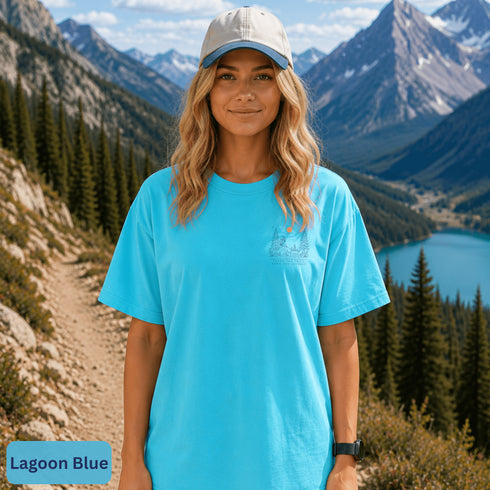 Comfort Colors 1717 unisex t-shirt featuring a coordinating left chest pocket design and large outdoor-inspired back graphic, shown in a lifestyle setting and available in multiple garment-dyed colours.