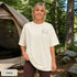 Comfort Colors 1717 unisex t-shirt featuring a coordinating left chest pocket design and large outdoor-inspired back graphic, shown in a lifestyle setting and available in multiple garment-dyed colours.