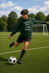 Person in a green hoodie with text on a soccer field