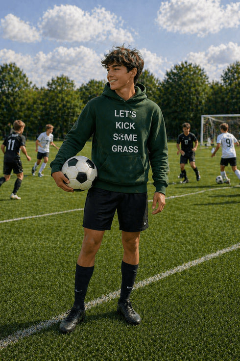Person holding a soccer ball on a soccer field with a humorous hoodie
