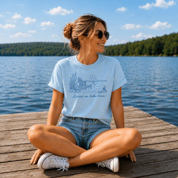 Livin' On Lake Time t-shirt featuring a lakeside chair and dock design inspired by Manitoba lake life and cottage weekends.