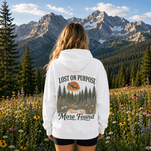 Vintage outdoor hoodie featuring a matching left chest graphic and a large back design inspired by hiking, forests, mountains, and adventure on a premium unisex hoodie displayed in an outdoor lifestyle setting.