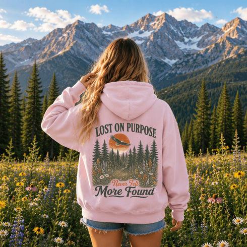 Vintage outdoor hoodie featuring a matching left chest graphic and a large back design inspired by hiking, forests, mountains, and adventure on a premium unisex hoodie displayed in an outdoor lifestyle setting.